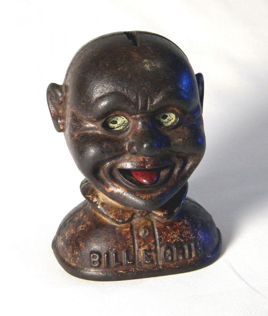 Bill E. Grin Mechanical Bank: J. & E. Stevens 1915 cast iron Bill E. Grin mechanical bank. Place a coin in the slot in the top of his head and he will stick out his tongue and his eyes roll upward, significant paint loss, works fi