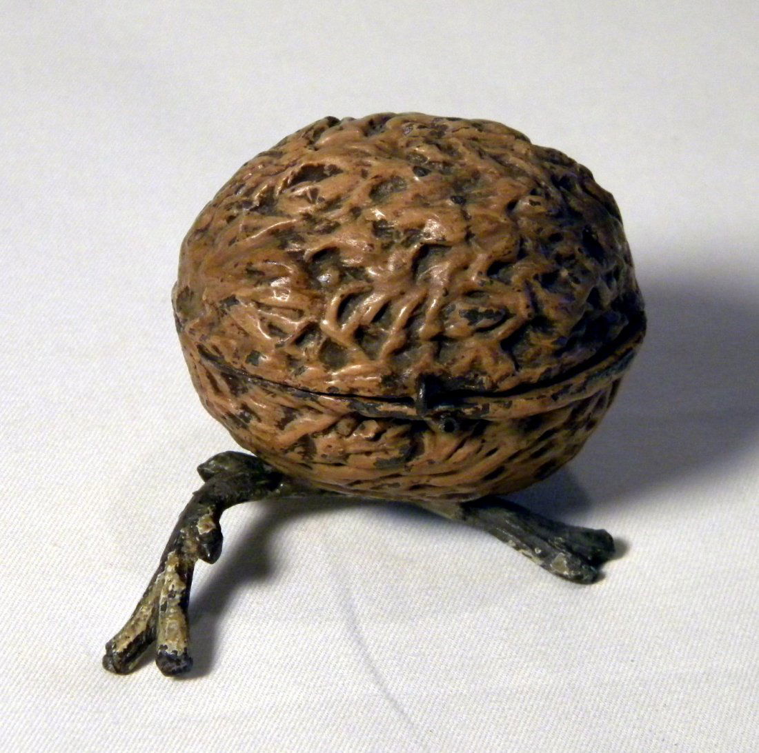 Painted Lead Walnut Still Bank: Most likely part of a rare figural still bank of a Kingfisher bird by the walnut, has original hinge, no clasp.
