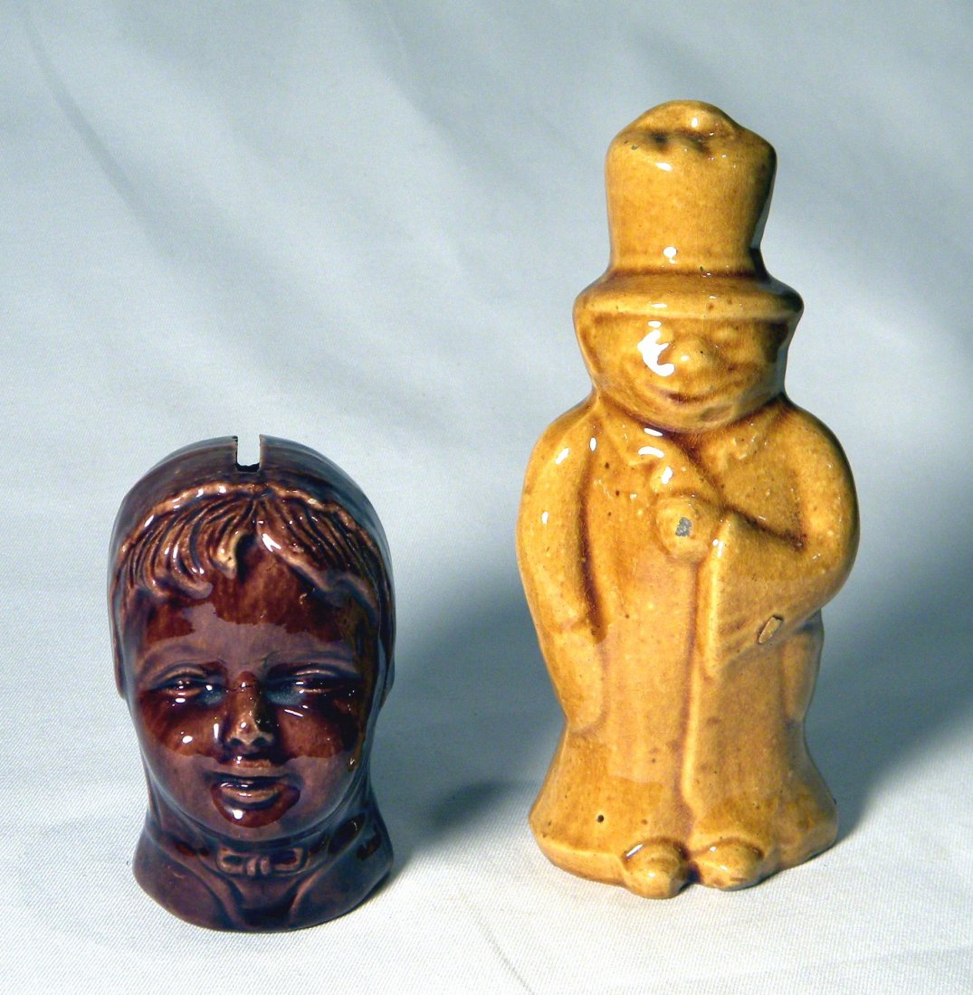 Two Pottery Still Banks: Yellowware Happy Hooligan, and brown girl with bonnet marked Austria, no chips.