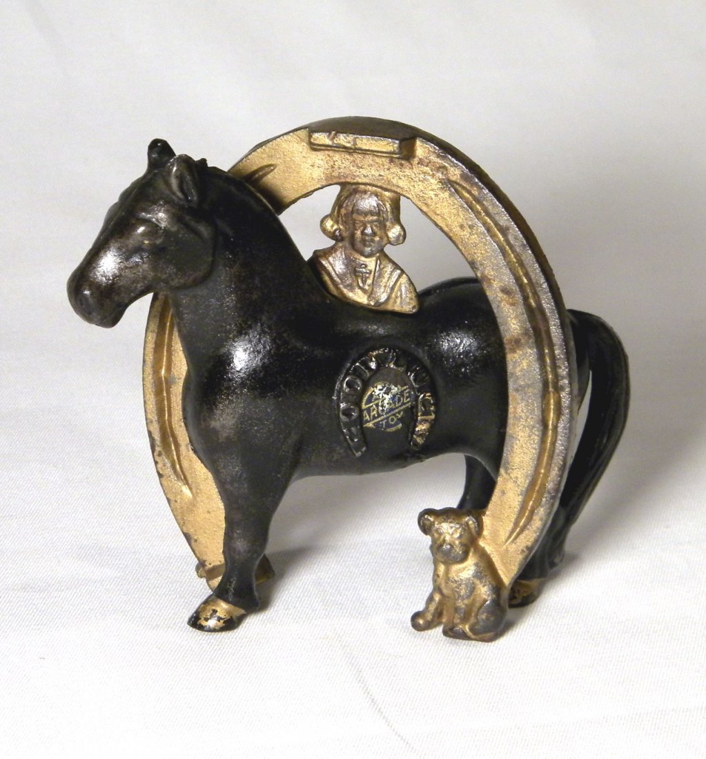 Buster Brown Good Luck Horseshoe Bank: Arcade Buster Brown Good Luck" horseshoe on side of horse, good portion of original Arcade sticker remains, some paint wear.