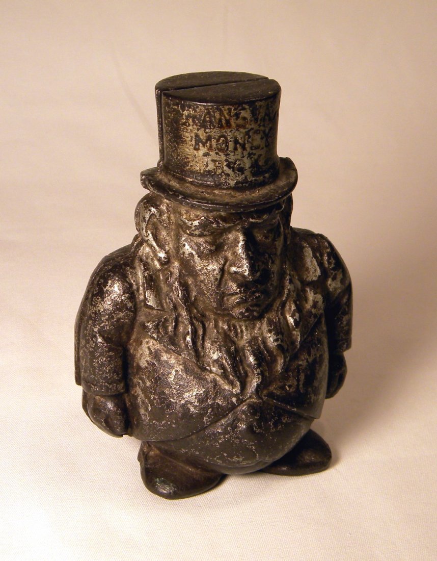 Cast Iron Transvaal Still Bank: Cast iron "Transvaal Money Box" figural still bank, manufactured by J. Harper England, this example does not have a hole in the mouth for a pipe, baseplate is missing, silver paint has significant wea