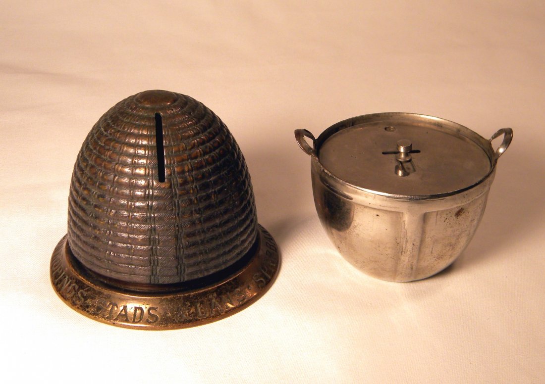 Lot of Two Still Banks: Basket Bank (smooth) by Victor M. Grab Co., and German brass Beehive still bank example reads JONKOPINGS STADS & LANS SPARBANK, key lock trap on bottom, excellent.