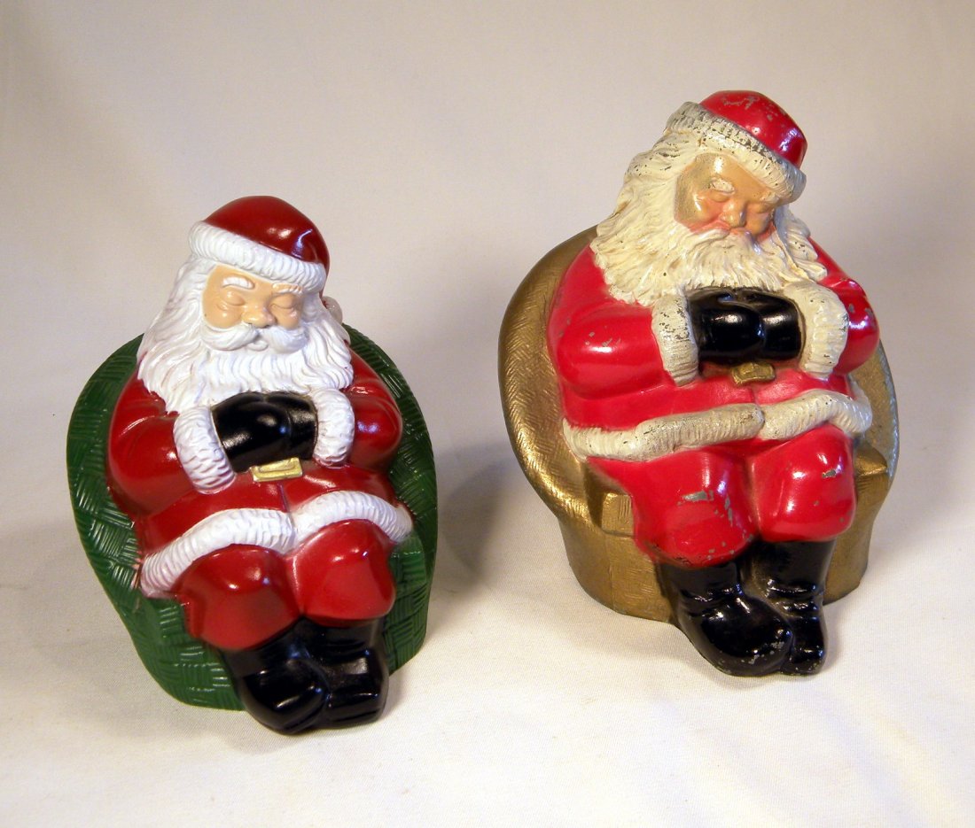 Two Sleeping Santa Still Banks: WM Sleeping Santa still bank, by Banthrico Ind. Inc., 6 1/2"h. and plastic Sleeping Santa still bank.