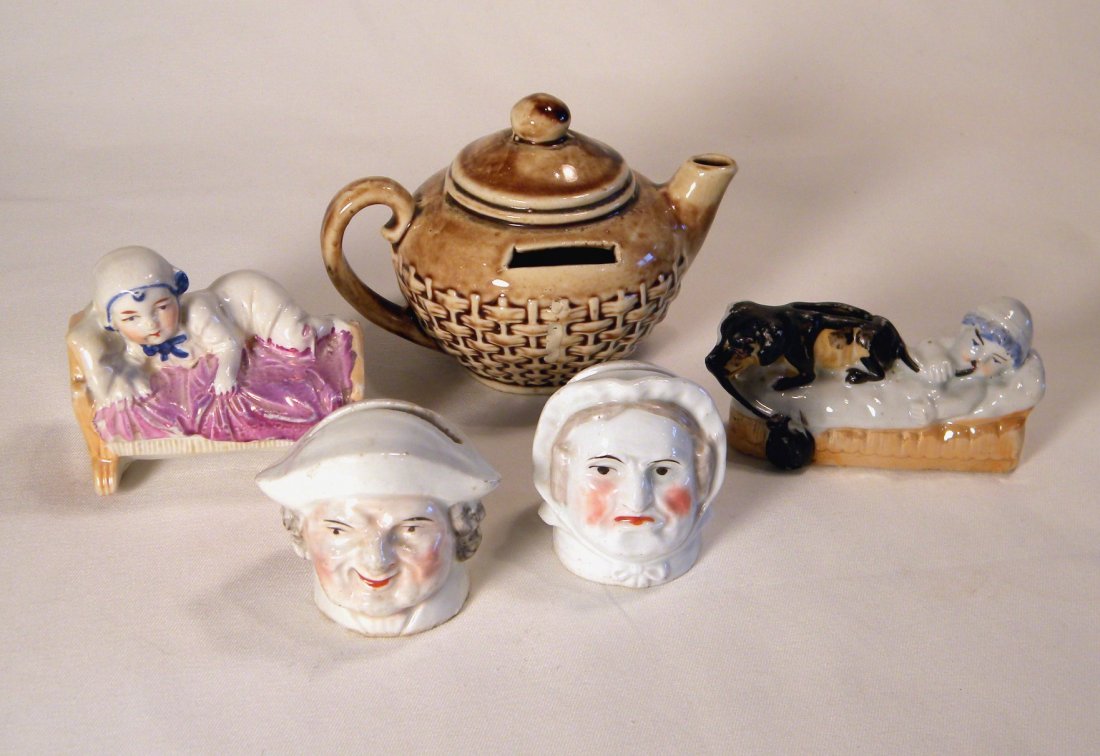 Lot of Five Pottery Still Banks: Van Dyk pottery Teapot, small Man and Woman, Baby in Cradle, and Boy with Dog on Daybed, all excellent.