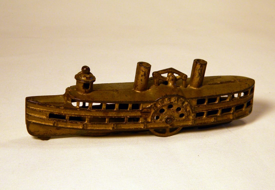 Cast Iron Steamboat Still Bank: Arcade cast iron Steamboat still bank, Arcade embossed on sides, original gold paint with some wear.