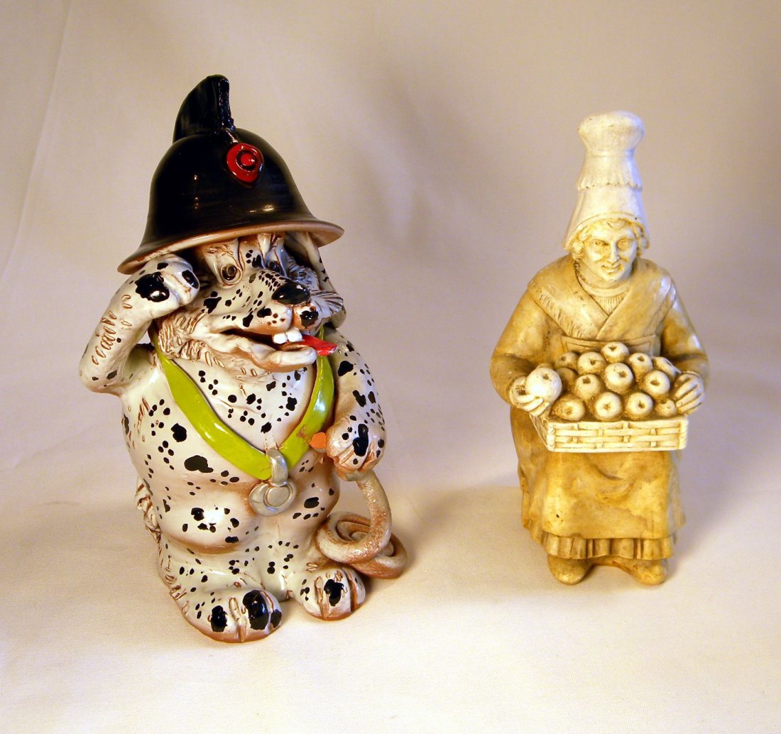 Two Pottery Still Banks: Whimsical pottery Firefighter Dog, and Woman with Basket of Fruit.
