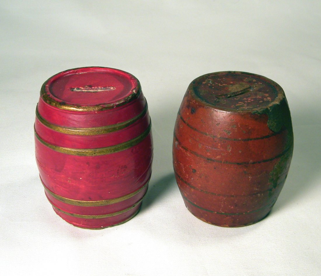 Lot of Two Early Pottery Barrel Banks: Two early earthenware pottery Barrel banks; one with raised gold bands, one with painted black bands.