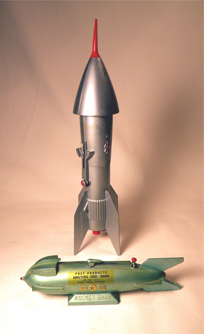 Two Rocket Mechanical Banks: "Mercury Rocket Bank" advertising "Post Products Employees Credit Union, Battle Creek, Mich." trap missing, and Rocket Bank by Astro Mfg. with original rubber tip.