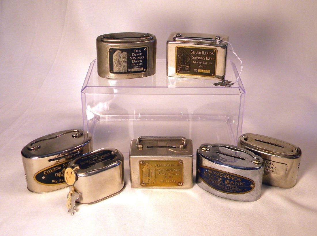 Lot of Seven Deposit Banks: Lot of 7 Deposit banks; "The Dime Savings Bank, Detroit, Mich", "Grand Rapids Savings Bank, Grand Rapids, Mich", "Citizens State Bank, Big Rapids, Mich", "Society for Savings" with key, "Grand Rapids 
