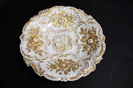 Dresden Porcelain Bas Relief Charger: White porcelain charger. Decorated in bas relief and gilt trim. Marked with blue crossed swords at the underside; 12in.D.