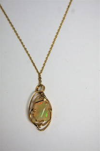 14K Gold and Opal Pendant Necklace: 14k gold pendant neclace. Set with Australian opal; 24in.L. x 1in. X .5in.(pendant)