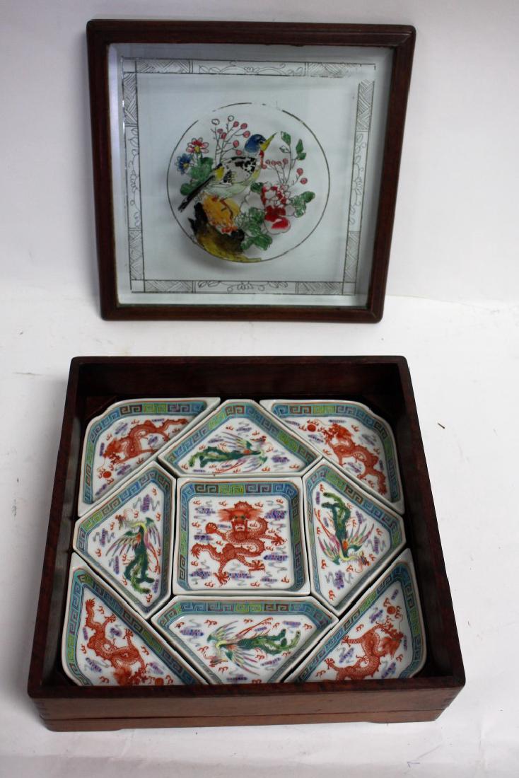 Chinese Porcelain Puzzle Dishes: Nine(9) enameled porcelain puzzle dishes. Wood case with painted glass top. Decorated with dragon and phoenix; 3.5in.H. x 11in. X 11in.(box)