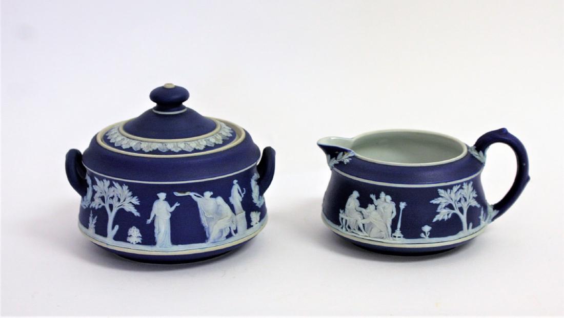 Jasperware Porcelain Sugar and Creamer: Porcelain sugar and creamer. Cobalt ground. White classical decoration. Marked Made in England; 3in.H. x 4.25in.W. ; 175007