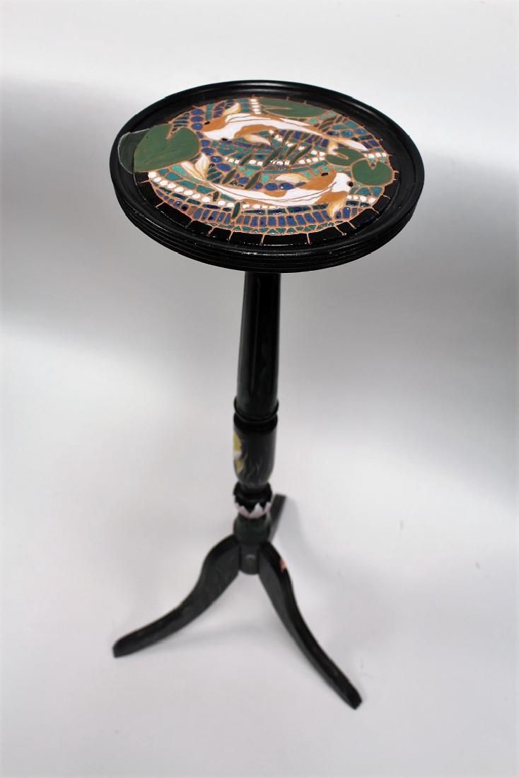 Unusual Enameled Ebonized Wood Stand: Ebonized tri-footed wood stand. Enameled top. Swimming fish decoration; 34in.H. x 11in.D.(top)
