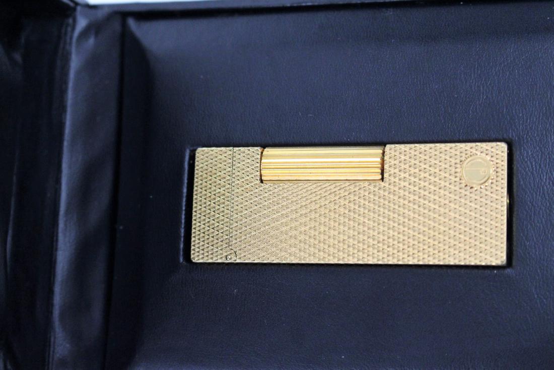 Dunhill Gold Tone Lighter in Box: Gold tone lighter in box; 2.5in. X 1in.(lighter), 4.75in. X 3.75in.(box)