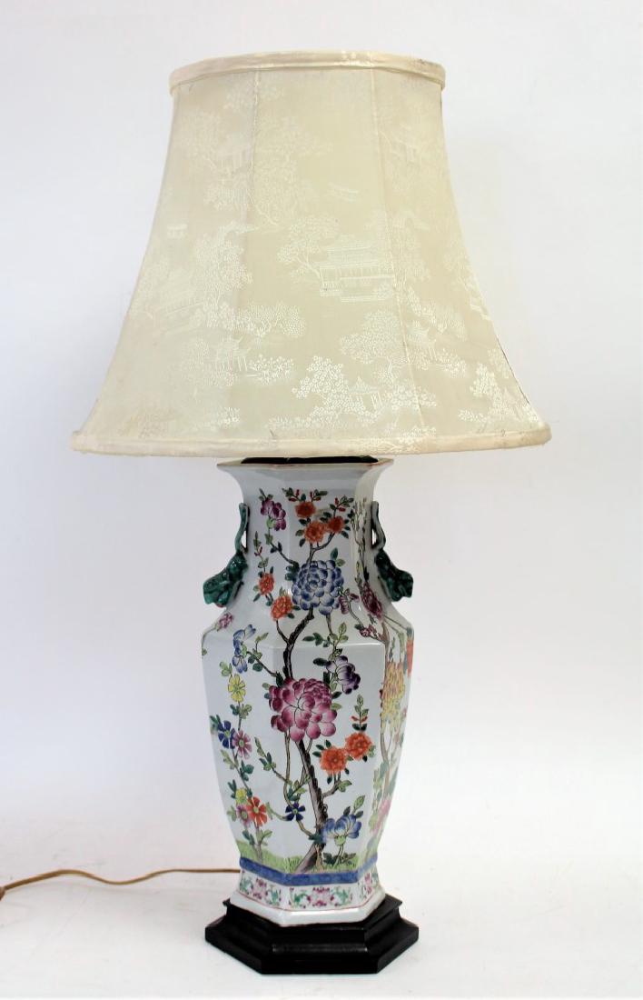 Chinese Porcelain Lamp: Painted and enameled porcelain lamp base. Squirrel handles. Silk shade; 30in.H.(overall) x 16in.D.(shade) x 7in.W.
