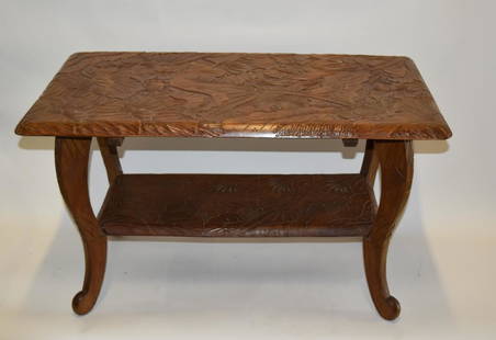 Japanese Carved Teakwood Table: Two(2) tiered carved teakwood table. Heavily carved flora and foliage decoration; 19in.H. x 32in.W. x 17in.D.