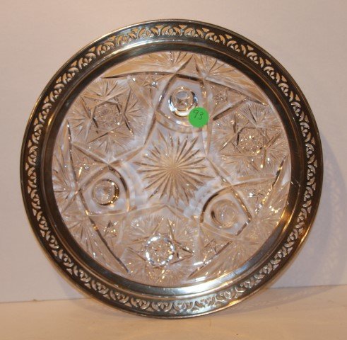 American Brilliant Cut Glass Cake Stand: Tri footed cut glass cake stand. Sterling silver rim; 2in. H. x 11in. D.