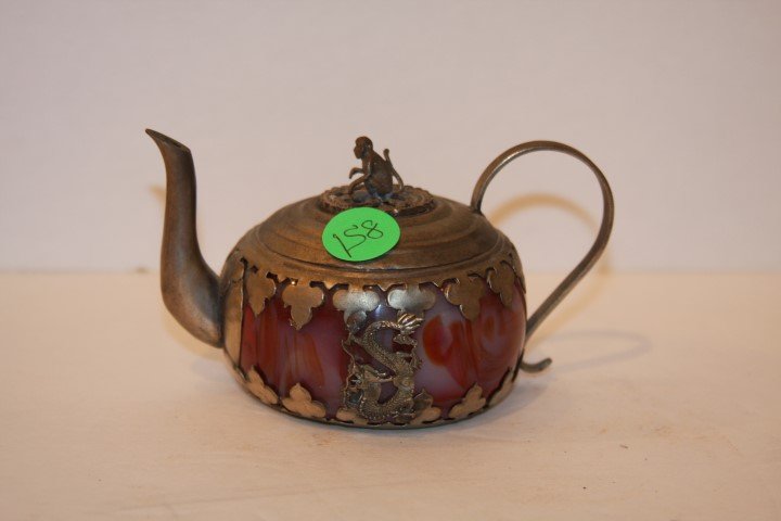 Chinese Silver and Agate Teapot: Silver mounted agate teapot. Mounted with a monkey finial; 2.75in. H. x 5in. W.