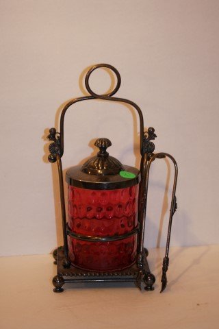 Victorian Cranberry Glass Pickle Caster: Thumbnail cranberry glass pickle caster. Silverplate holder and tongs. Marked Meriden; 10.5in. H. x 4.75in. W.