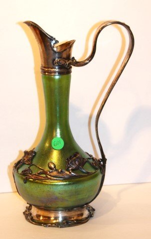 Loetz Silver Overlay Ewer: Irridescent art glass ewer withsilver overlay and raised floral decoration; 12in. H. x 7in. W.