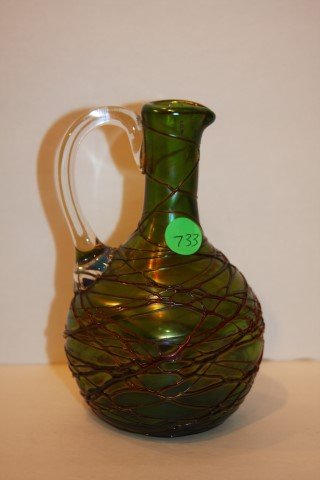 Loetz Art Glass Cruet: Irridescent art glass cruet. Applied thread design and handle; 7in. H. x 4in. W.