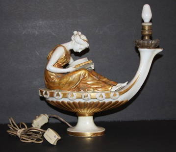 Capodimonte Porcelain Aladdin's Lamp: Figural porcelain Aladdin's lamp. Girl reading book. Gold dore trim. Marked on base "N" with crown; 8in. H. x 10in. W.