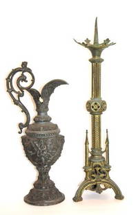 Two(2) Pieces: Miscellaneous Metalware: 19th C. ornate Spelter ewer with Bacchus head, goddess and cherub in relief, 17.5in. H. x 5.5in. D.; 19th C. Gothic bronze candlestick(missing one(1) steeple at base), 23in. H. x 6.5in. W.