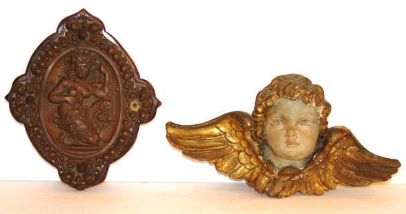 Two(2) Miscellaneous Wall Plaques: Carved and polychromed wood cherub wall hanger, 8.5in. X 7.5in.; Brass repoussed wall plaque decorated with a semi nude woman, 12in. X 6in.