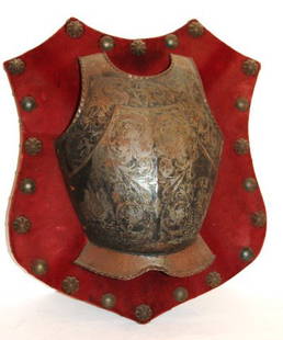 Early Armour Wall Plaque: Tooled metal armour section mounted on a wood plaque; 17.5in. H. x 15in. W.