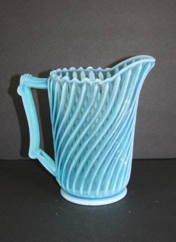 Victorian Opalescent Glass Pitcher: Beatty blue opalescent swirled glass pitcher; 8in. H. x 7in. W.