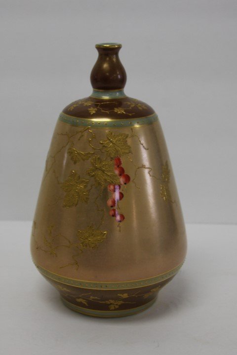 Royal Bonn Gilt Porcelain Vase: Gilt decorated porcelain vase. Enameled leaf and berry decoration. Marked at the underside; 8in.H. x 5in.W.
