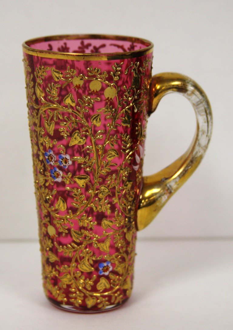 Moser Enameled Glass Demi Tasse Cup: Intricately enameled glass demi tasse cup. Applied gilt glass handle; 4.25in.H. x 3in.W.