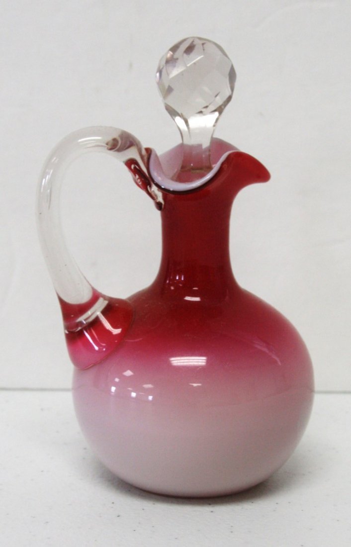 Webb Glass Cruet: Webb Cranberry to pink glass cruet. Applied glass handle ; 6.25in.H.