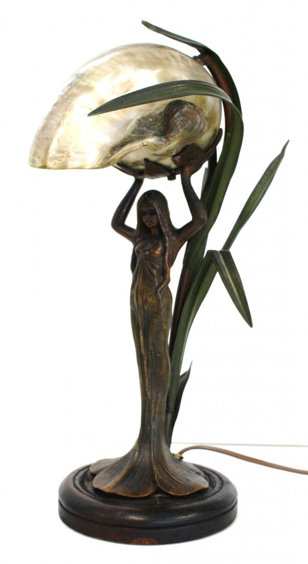 Art Nouveau Bronzed Figural Nautilus Lamp: Bronzed figural boudoir lamp. Nude girl rising from marsh grass. Arms raised to support a nautilus shell shade. Wood base; 13.5in.H. x 9in.W.