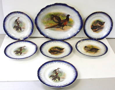 Seven(7) Piece Ironstone Dish Set: Seven(7) piece set. Platter and six(6) plates. Game bird transfers. Artist signed, Edwin Megargee. Marked Sterling China at the underside; 13in.(platter), 8.5in.(plates)