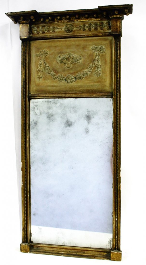 Federal Period Giltwood Trumeau Mirror: Carved and gilt decorated wood mirror. Center lion head carving. Carved and painted gesso insert. Lemon gold finish; 38.5in.H. x 16in.W., 1975in.W. (crown)