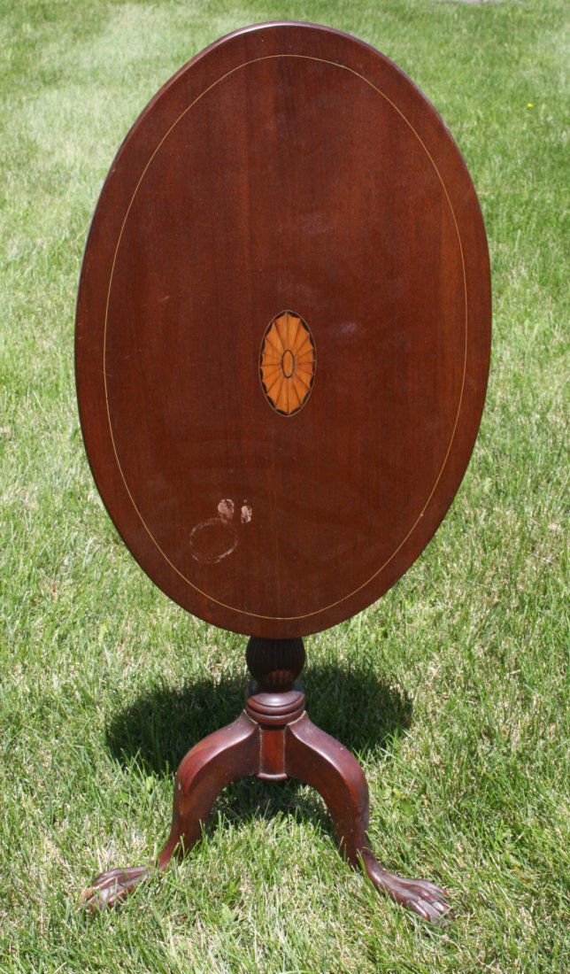 Inlaid Mahogany Tilt Top Stand: Oval tilt top stand. Inlaid rosettee decoration;28.5in.H. x 27.5in.W. x 17.25in.D.