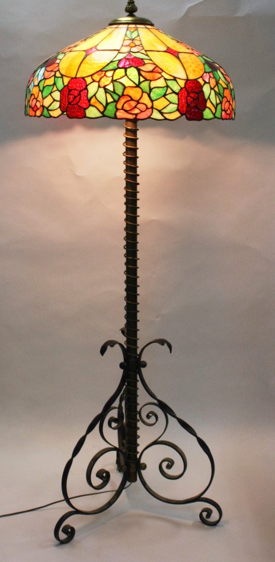 Victorian Leaded Glass Piano Lamp: Leaded glass shade with floral design. Wrought iron and brass tripod base; 65.5in.H. x 22.5in.diameter(shade)