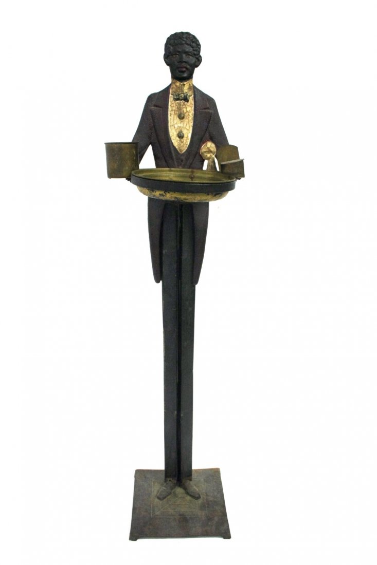 Black Americana Cast Iron Smoke Stand: Painted cast iron figural smoke stand. Brass ashtray insert and match holder. Marked: Patent Applied For at the base; 36in.H. x 9in.W. x 7.5in.(base)