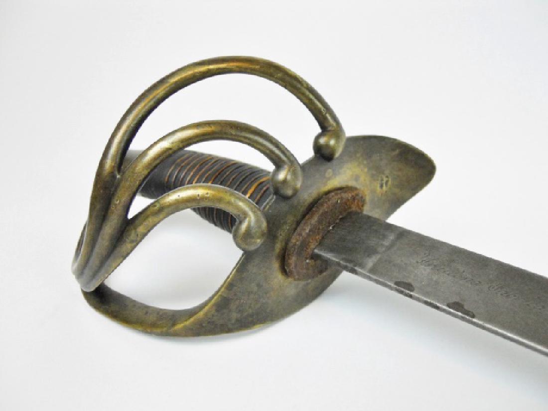 Spanish Artllery Sword, Toledo, 1869 Date: 19th C. Spanish M1842 Cavalry sword. Brass four branch guard with wire wrapped leather grip, marked with crown and "R V". Curved flat heavy steel blade signed, "Artilleria Fabrica De Toledo Ano de 186