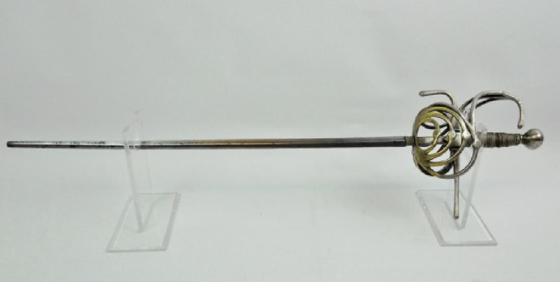 Antique Italian Child Sized Rapier: Early Italian blunted child's rapier. Plated brass basket style guard with wire wrapped wood grip and ball pommel. Straight steel blade measures 17.25"