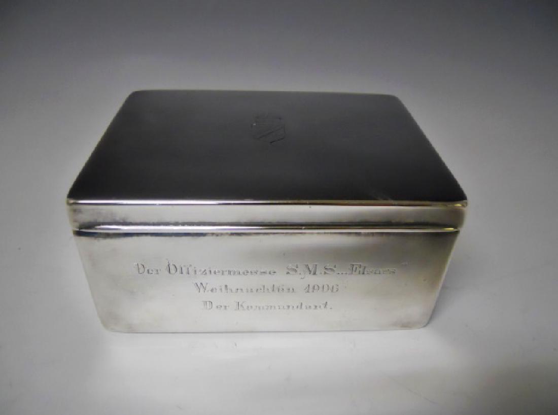 WW1 Era German Imperial Desk Top Cigar Box, 1906: Silver plated hinge lidded cigar box with cedar wood lining. Box with crowned heraldic shield engraved on lid, front panel with engraved presentation, "Der Offiziermesse S.M.S. Elsass Weihnachten 1906
