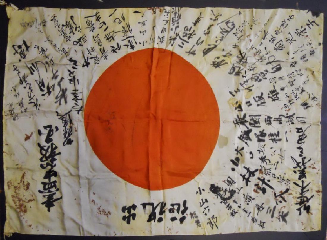 WW2 Japanese Silk Flag with Kanji: WW2 Original Japanese battle flag. White silk with red center disk and leather tabs at hoist. Profuse kanji characters in black ink cover the flag. Scattered staining with tear at hoist tab. Flag meas