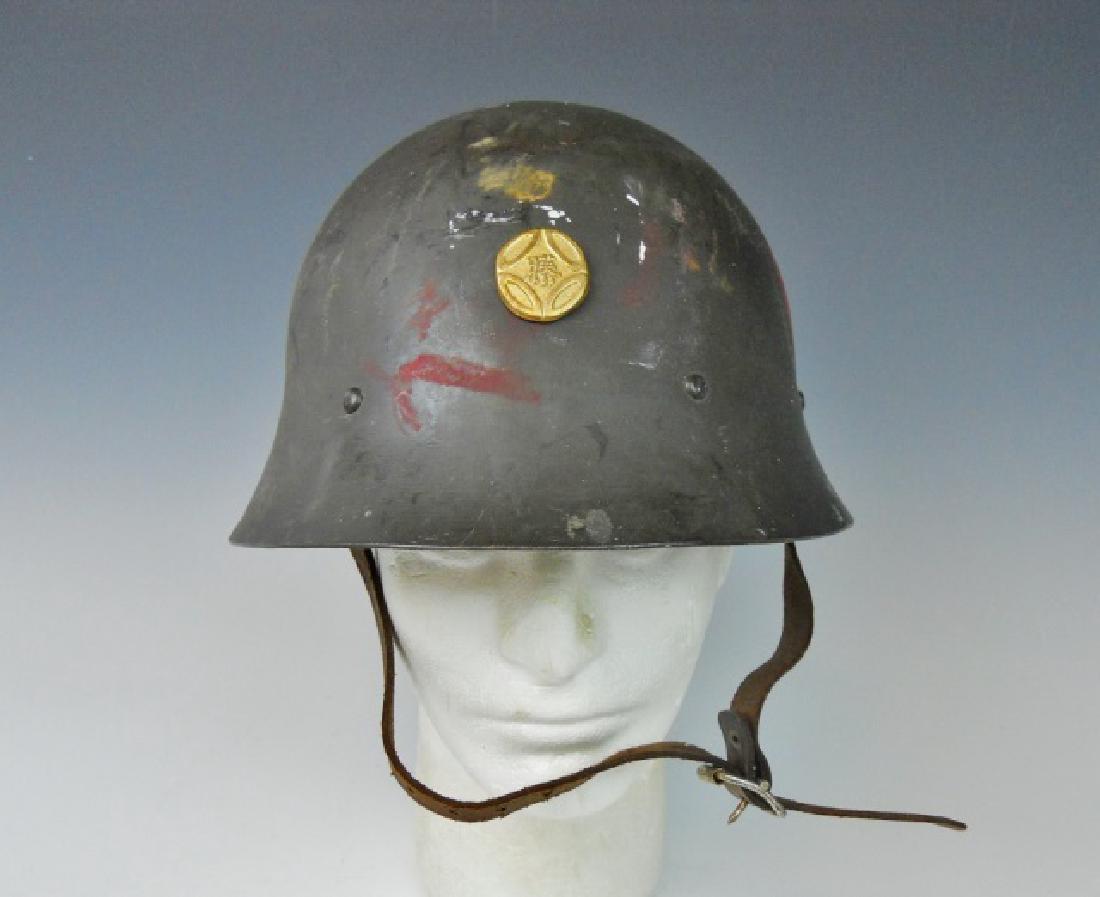 WW2 Japanese Type 90 Combat Helmet: WW2 Original Imperial Japanese Type 90 combat helmet. Dark olive drab painted surfaces,with hand painted kanji characters in red and disk, gilt metal insignia. Interior with kanji marked leather liner