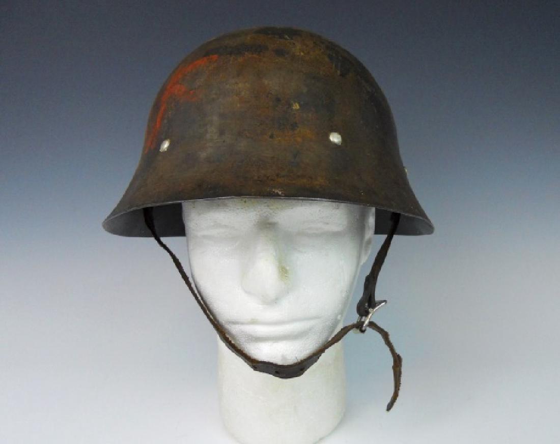 WW2 Japanese Type 90 Helmet: WW2 Original Imperial Japanese Type 90 helmet. Mottled dark olive drab painted surfaces,with hand painted kanji characters in red. Interior with Kanji marked leather liner with cushions and leather ch