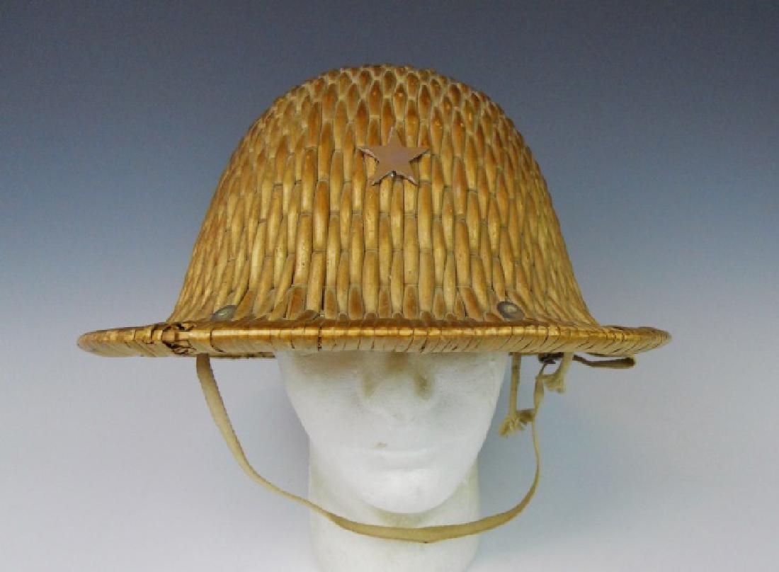 WW2 Imperial Japanese Army Pith Helmet: WW2 Original Imperial Japanese Army pith helmet. Woven rattan construction with painted metal star insignia. Interior with canvas and leather liner and chinstrap with ink Kanji signature.