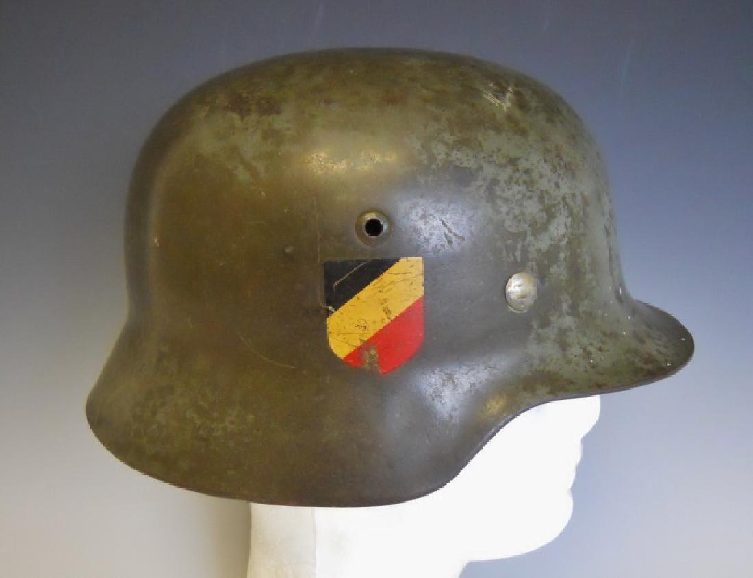 WW2 German M1935 Heer Double Decal Combat Helmet: WW2 Original German M1935 Helmet with Wehrmacht eagle decal and national shield decal. Helmet with apple green painted surfaces, interior stamped "ET 64" and "4671" with "Matern" written in pencil. In