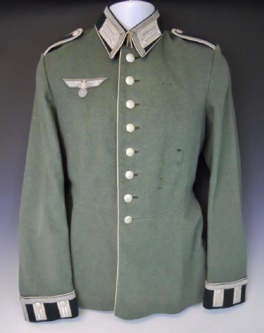 WW2 German Heer Infantry NCO Parade Tunic, Named: WW2 Original German M1936 NCO parade tunic. Quality green-grey wool construction with eight button front closure and hooked collar. Tunic with white piping denoting infantry and bullion litzen with bu