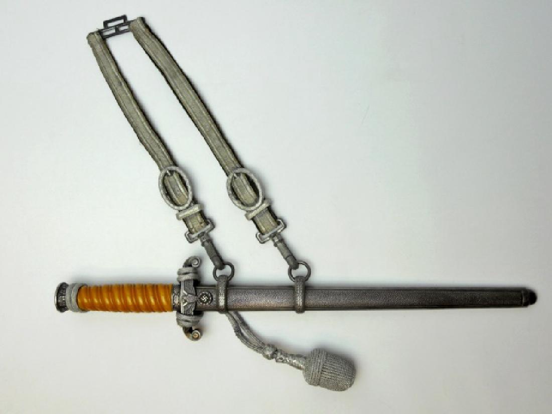 WW2 German M1935 Heer Dress Dagger, Puma: WW2 Original M1935 Heer officer's dress dagger with hangers. Steel blade with etched maker mark "PUMA SOLINGEN". Orange celluloid spiral grip with oak leaf decorated pommel and ferule, cross guard wit